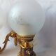 Wall lamp in gilded bronze with a lion's head and engraved globe.