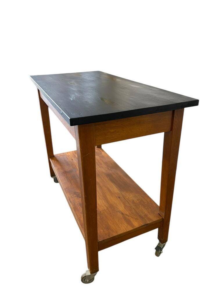 Vintage wooden high table on wheels
