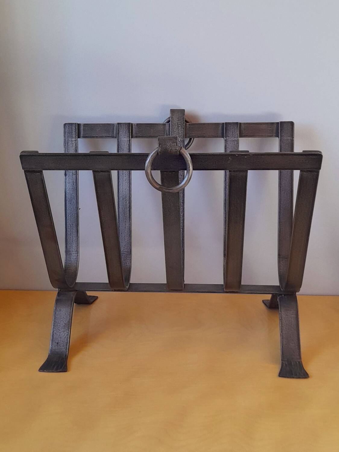 Brutalist magazine rack in forged steel, 1950.