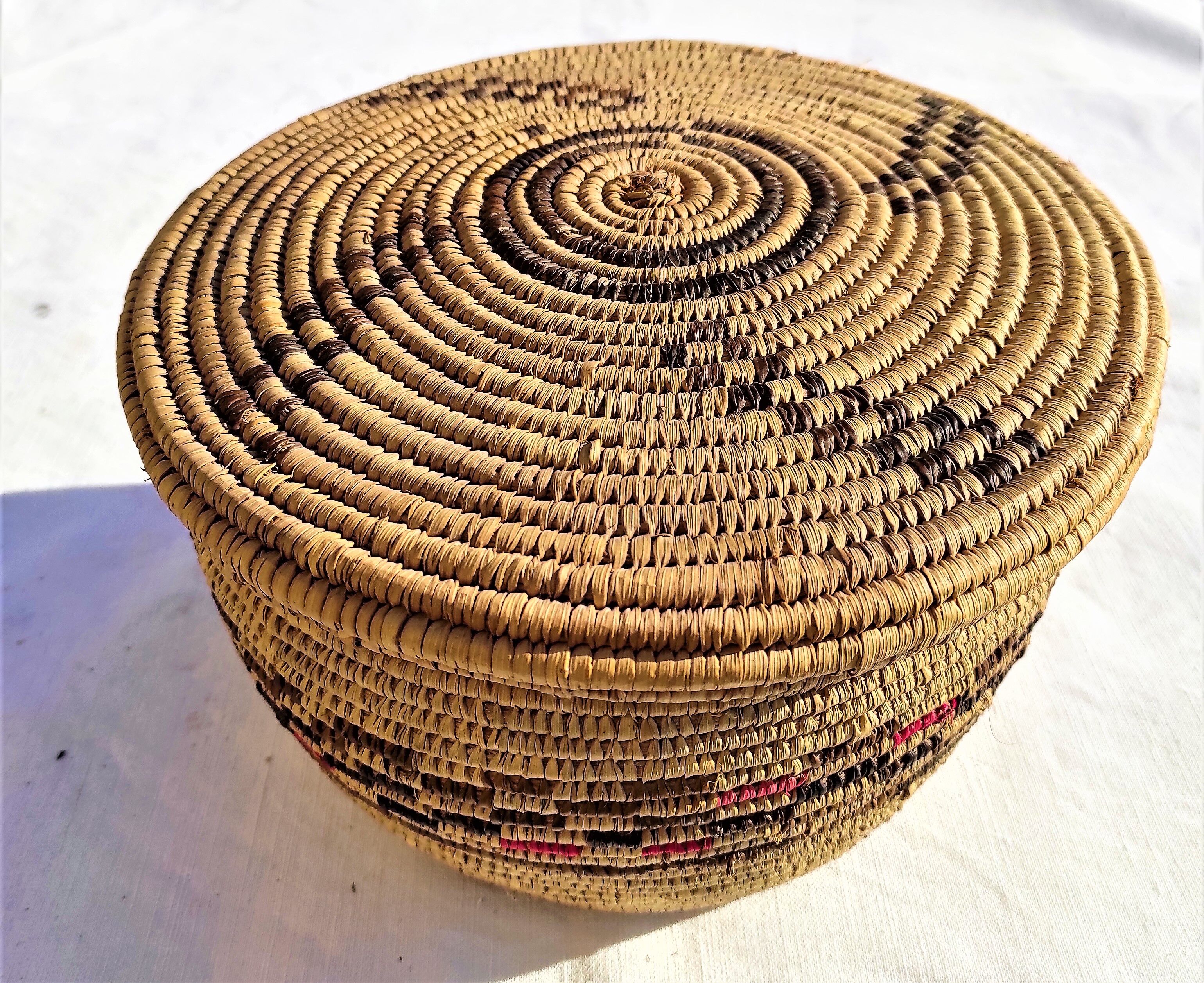 Antique basket with ethnic lid with black/brown and red décor