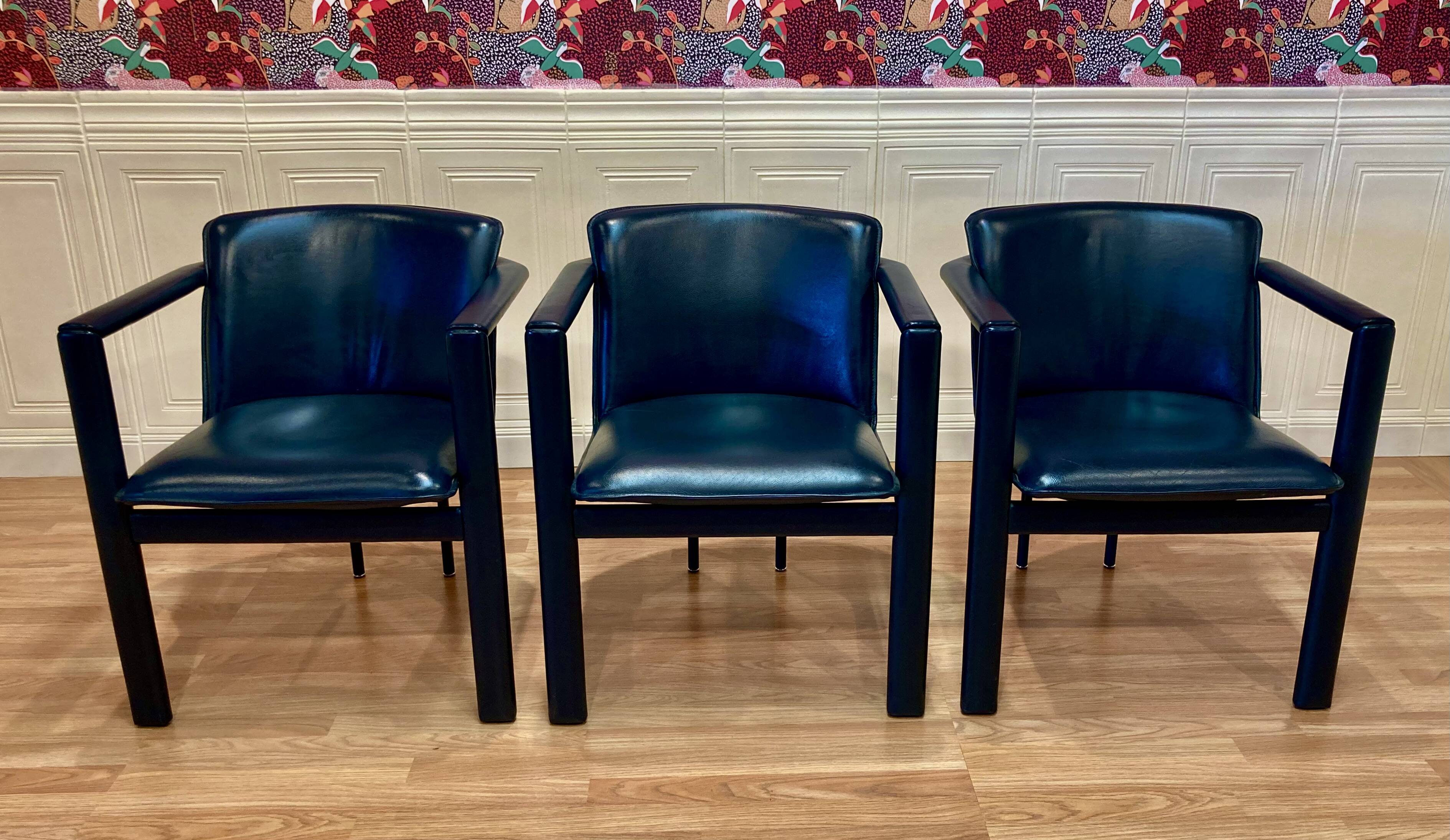 Set of 3 designer leather and metal armchairs.