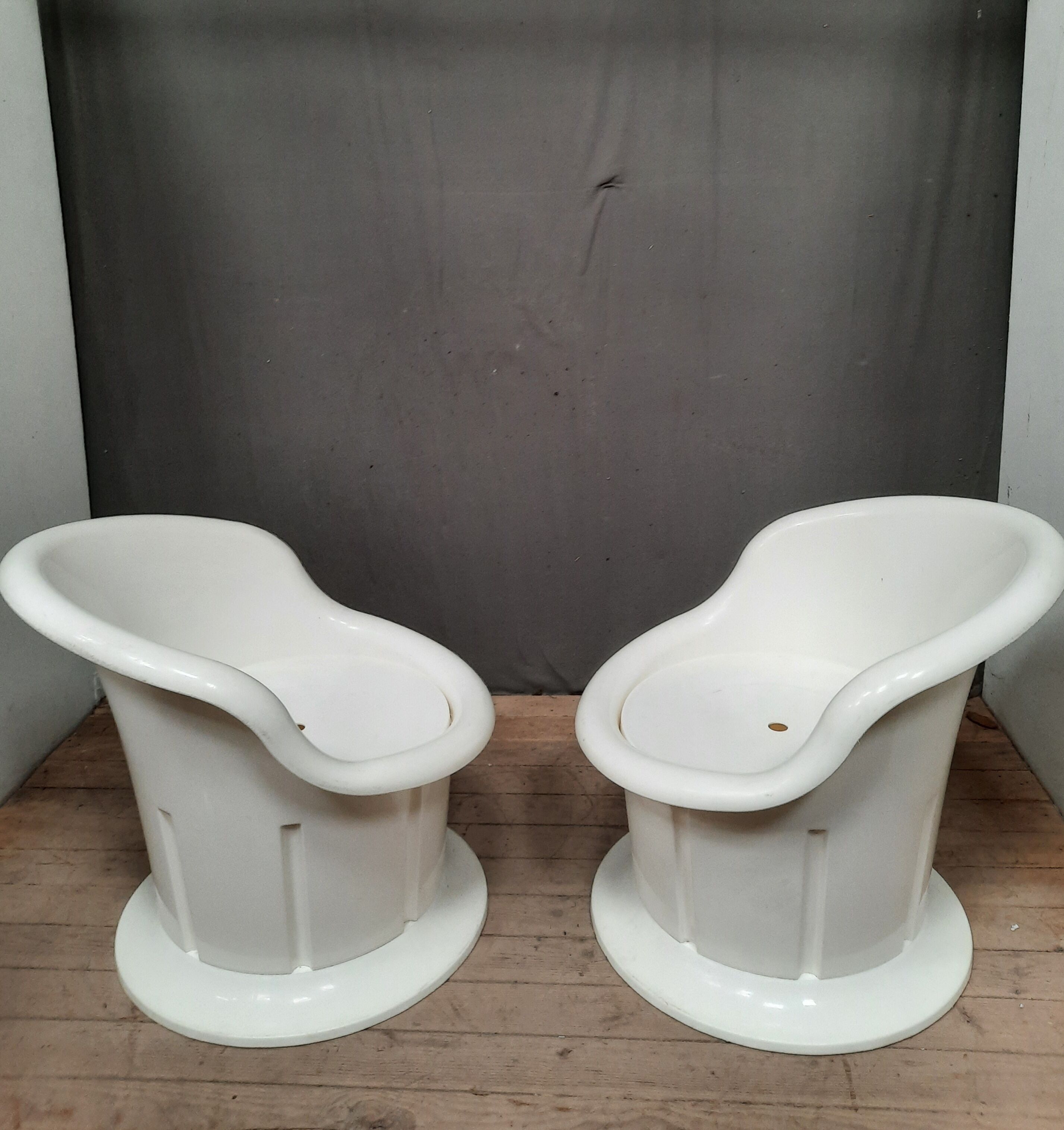 Pair of white plastic armchairs