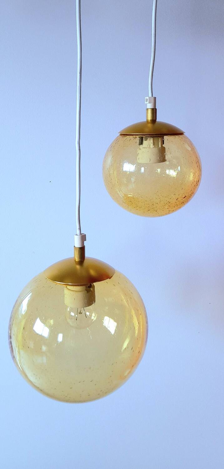 Set of 2 bubbled amber glass globe pendants