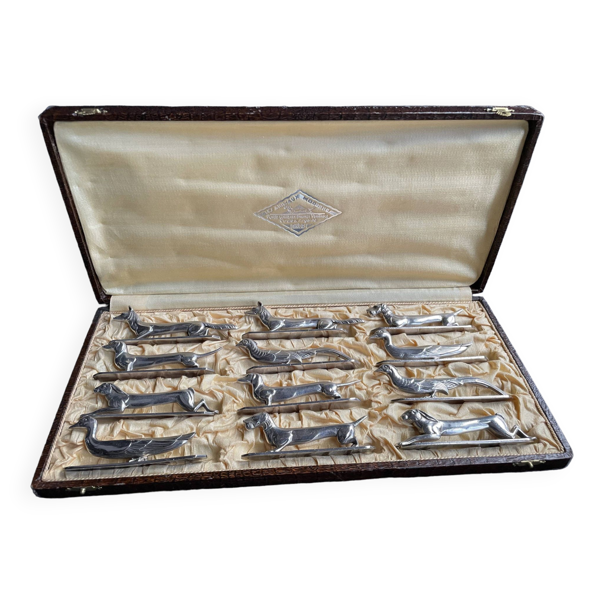 Serie de 12 porte couteaux animalier métal argenté Gallia