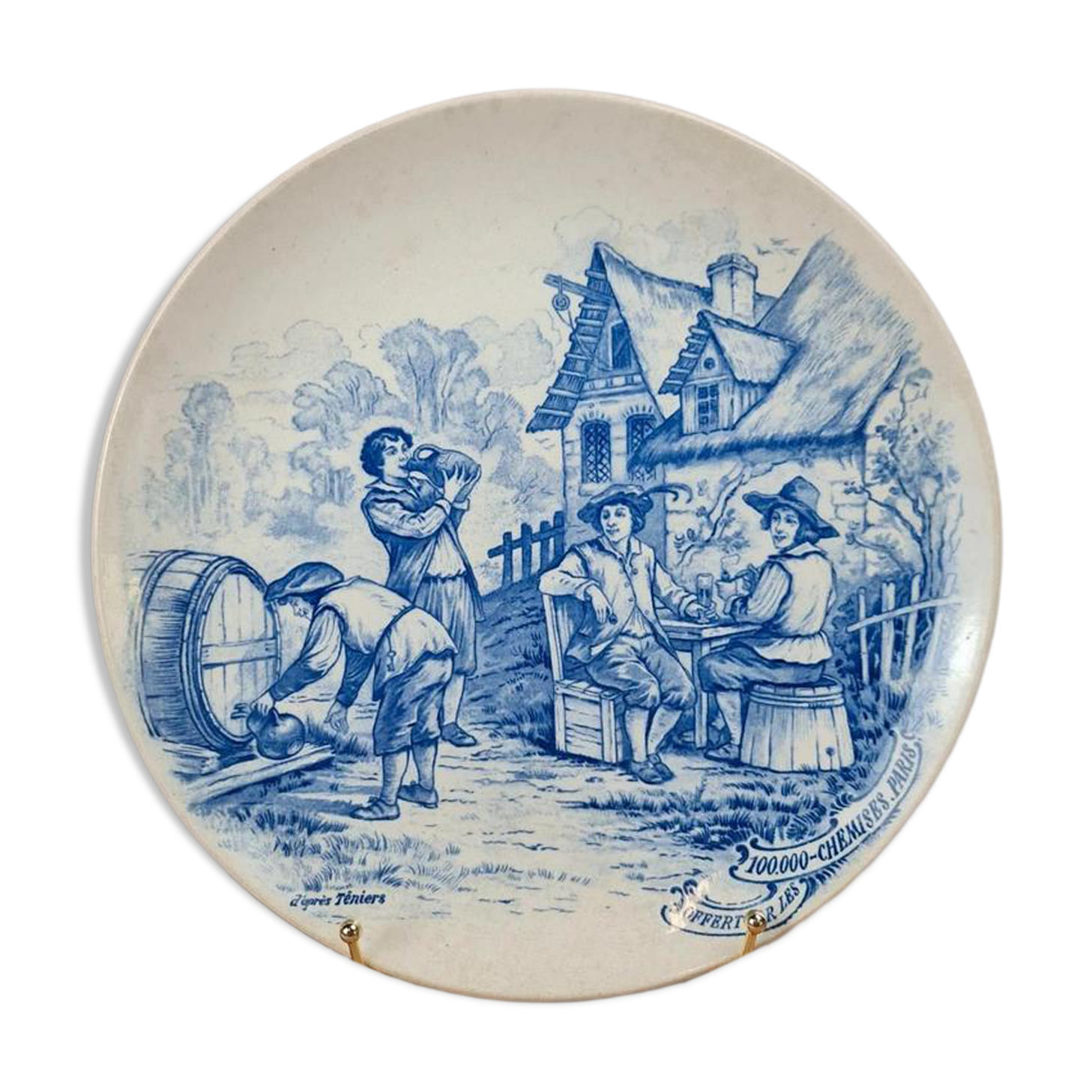 Old advertising plate with blue decoration after Teniers – 100,000 Shirts Paris