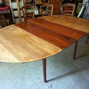 Elegant round teak table with extension.