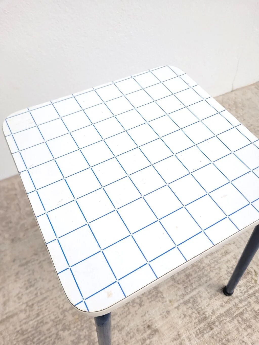 Vintage 80s melamine stool in navy blue checkered pattern.