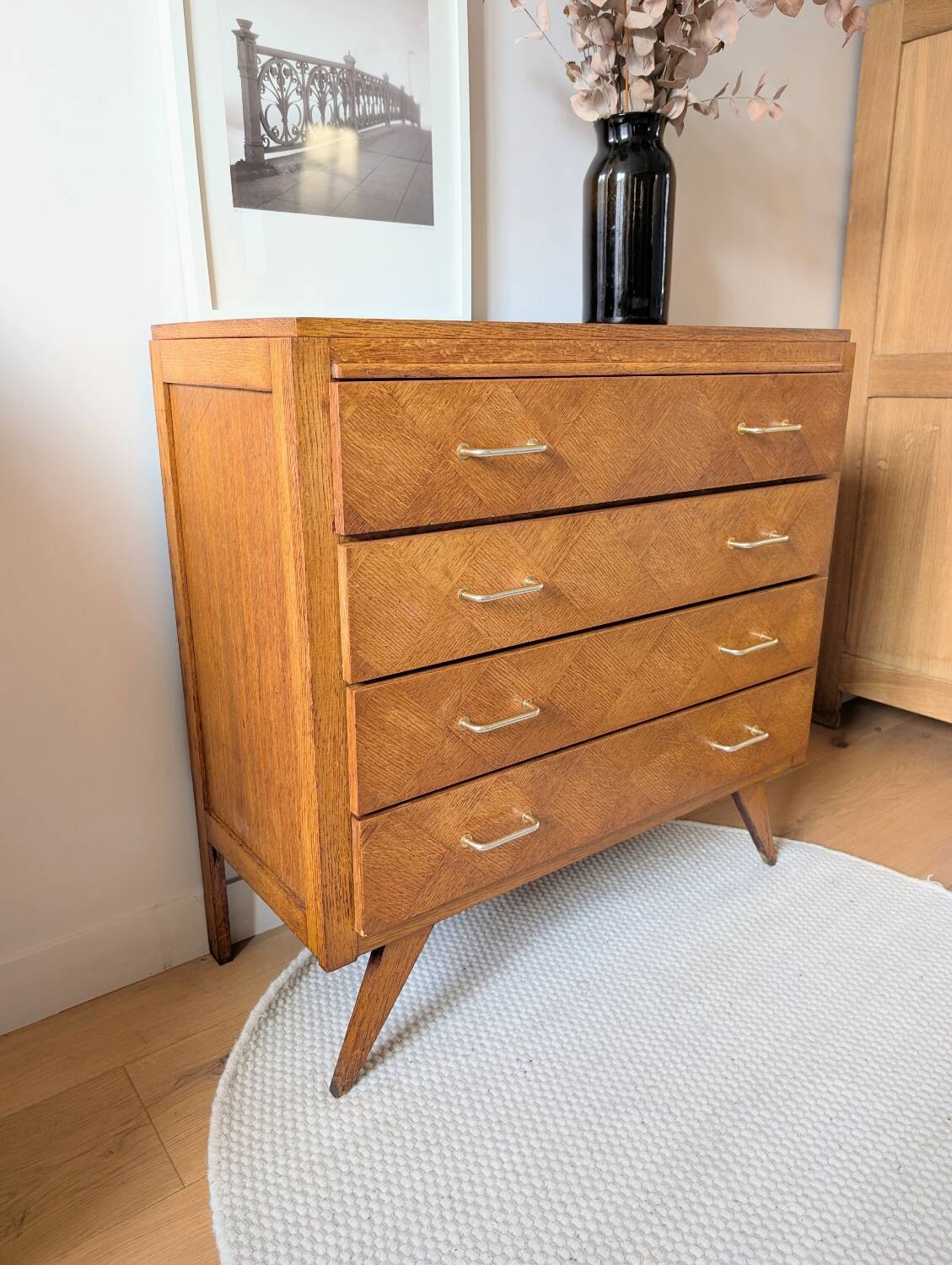 Vintage chest of drawers with checkerboard and compass feet