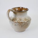 Glazed ceramic jug with plant decoration