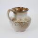 Glazed ceramic jug with plant decoration