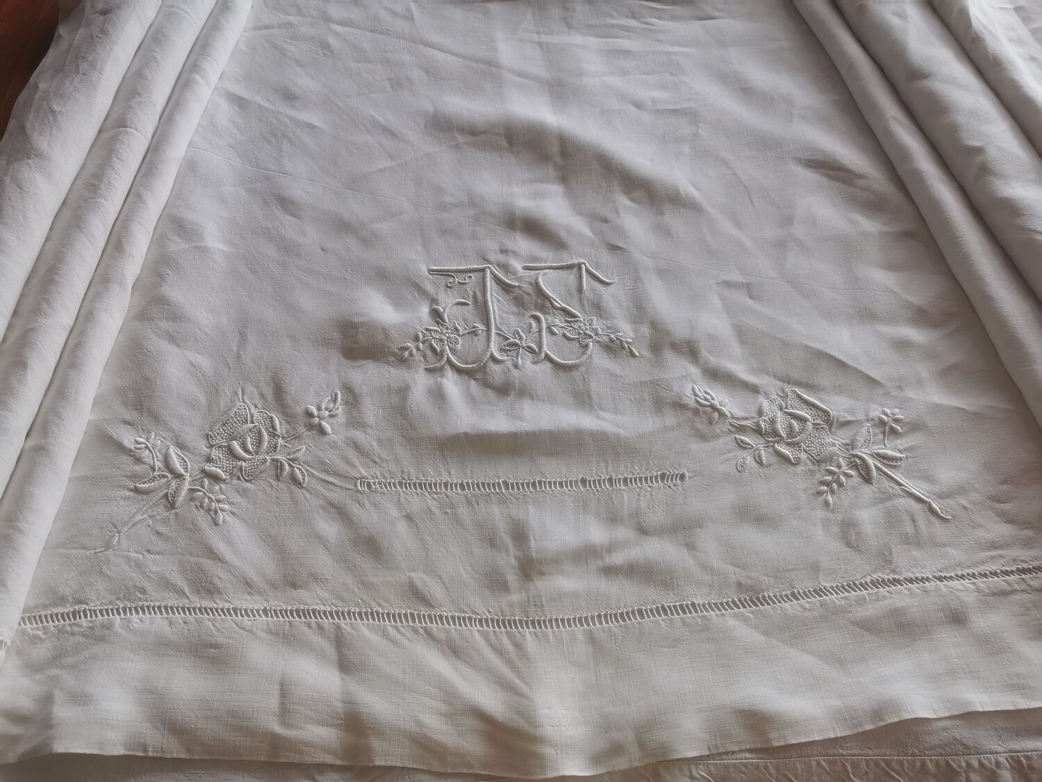 Antique embroidered linen sheet with a monogram.