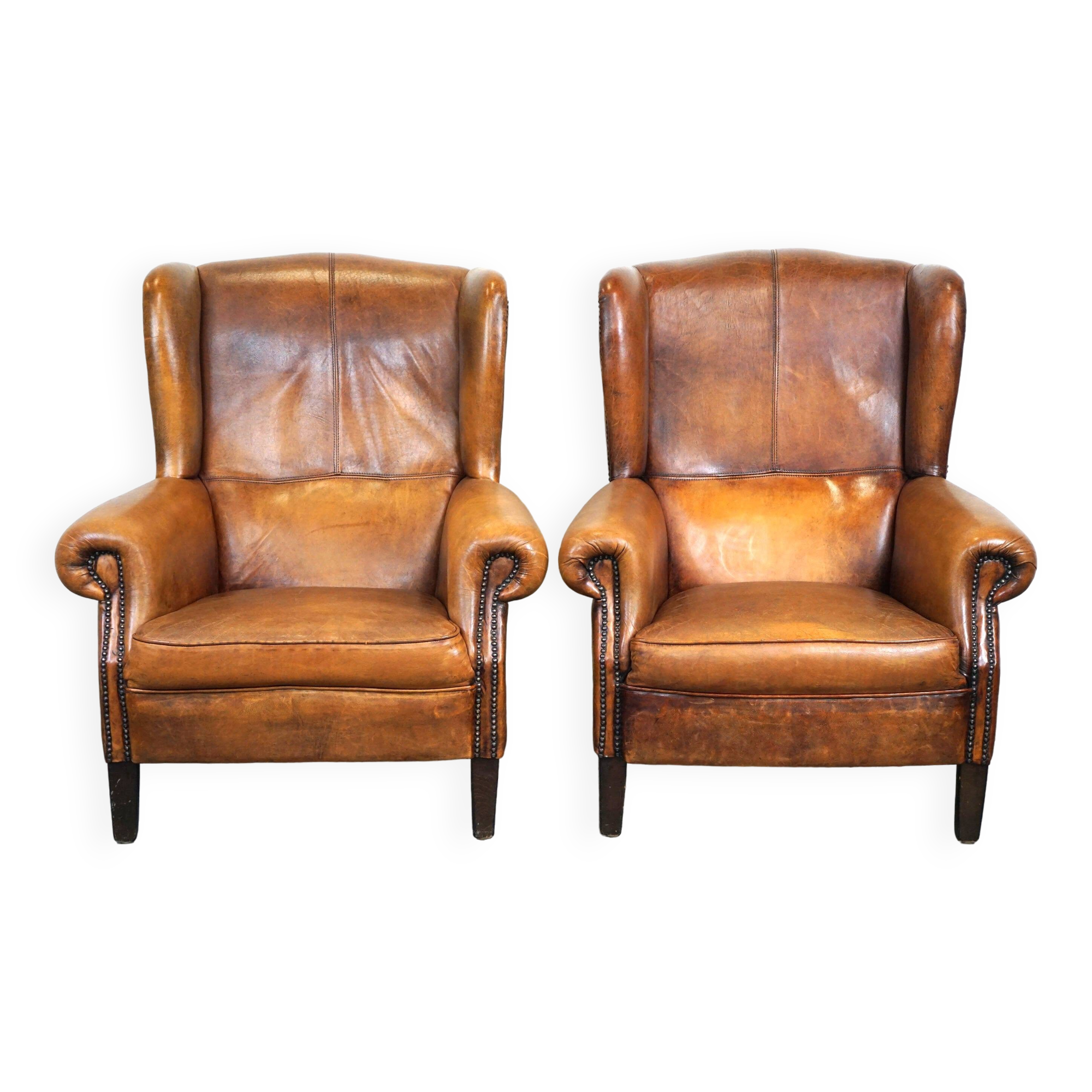 Set of 2 beautiful and correct sheep leather wingback armchairs with fixed seat cushions