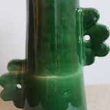 Handmade ceramic abstract vase with asymmetrical handles and fir green flowers