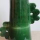Handmade ceramic abstract vase with asymmetrical handles and fir green flowers