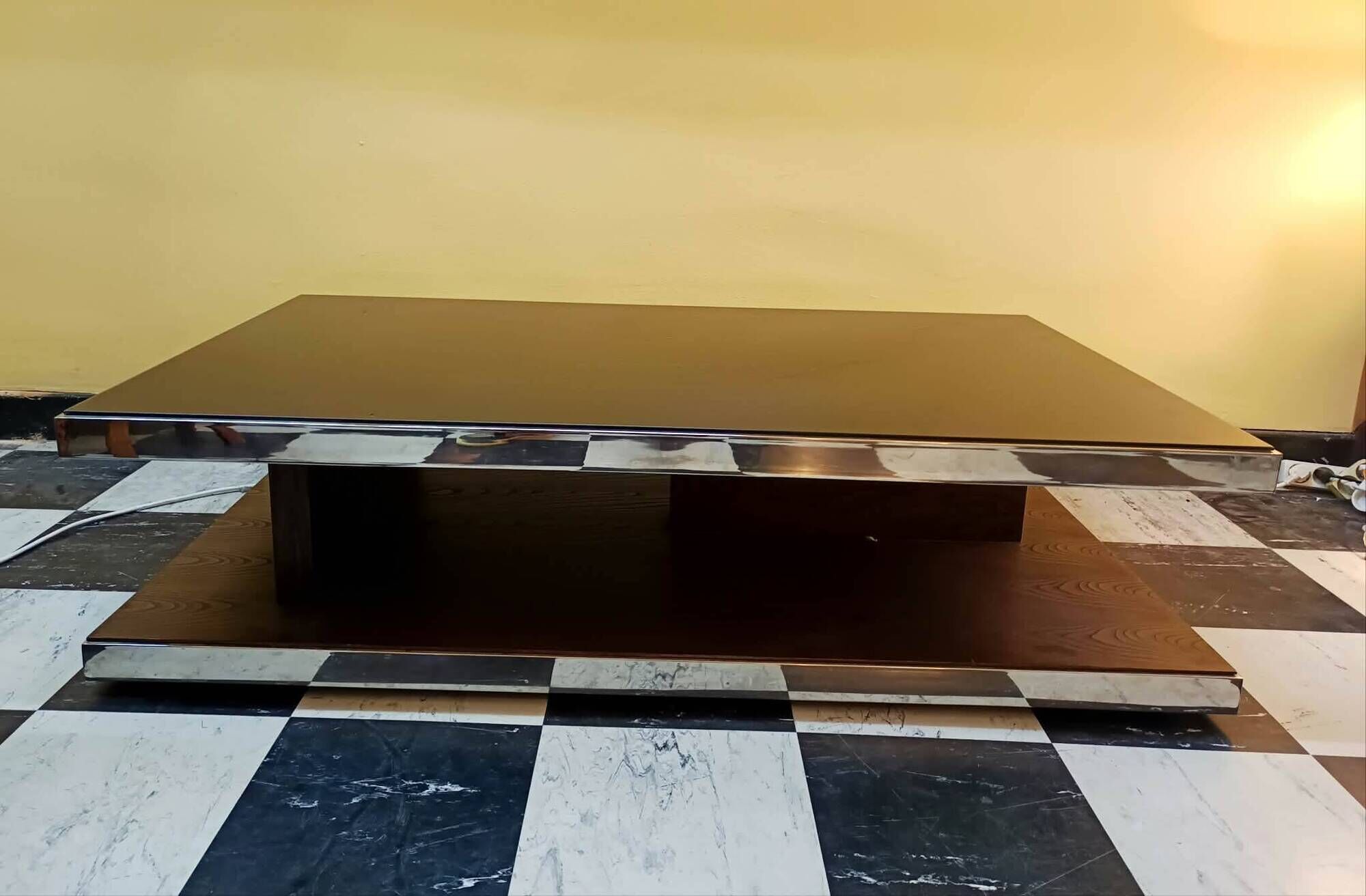 Designer coffee table in glass and chrome metal.