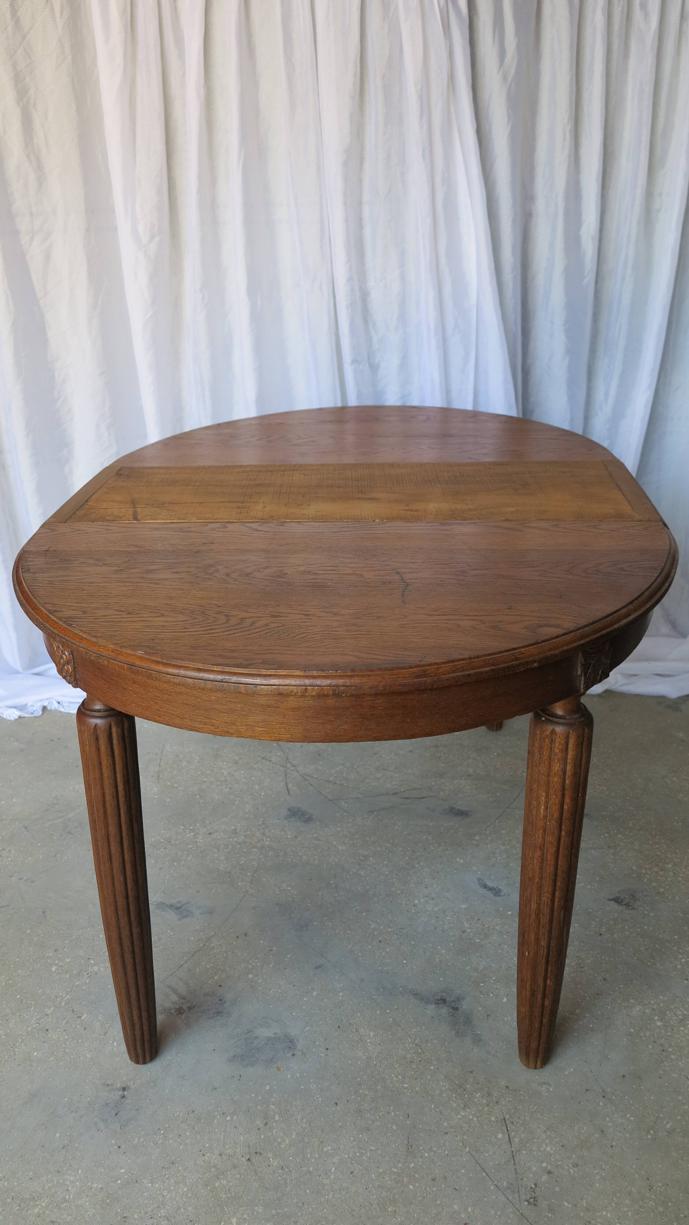 1930s oak dining table, slightly oval.