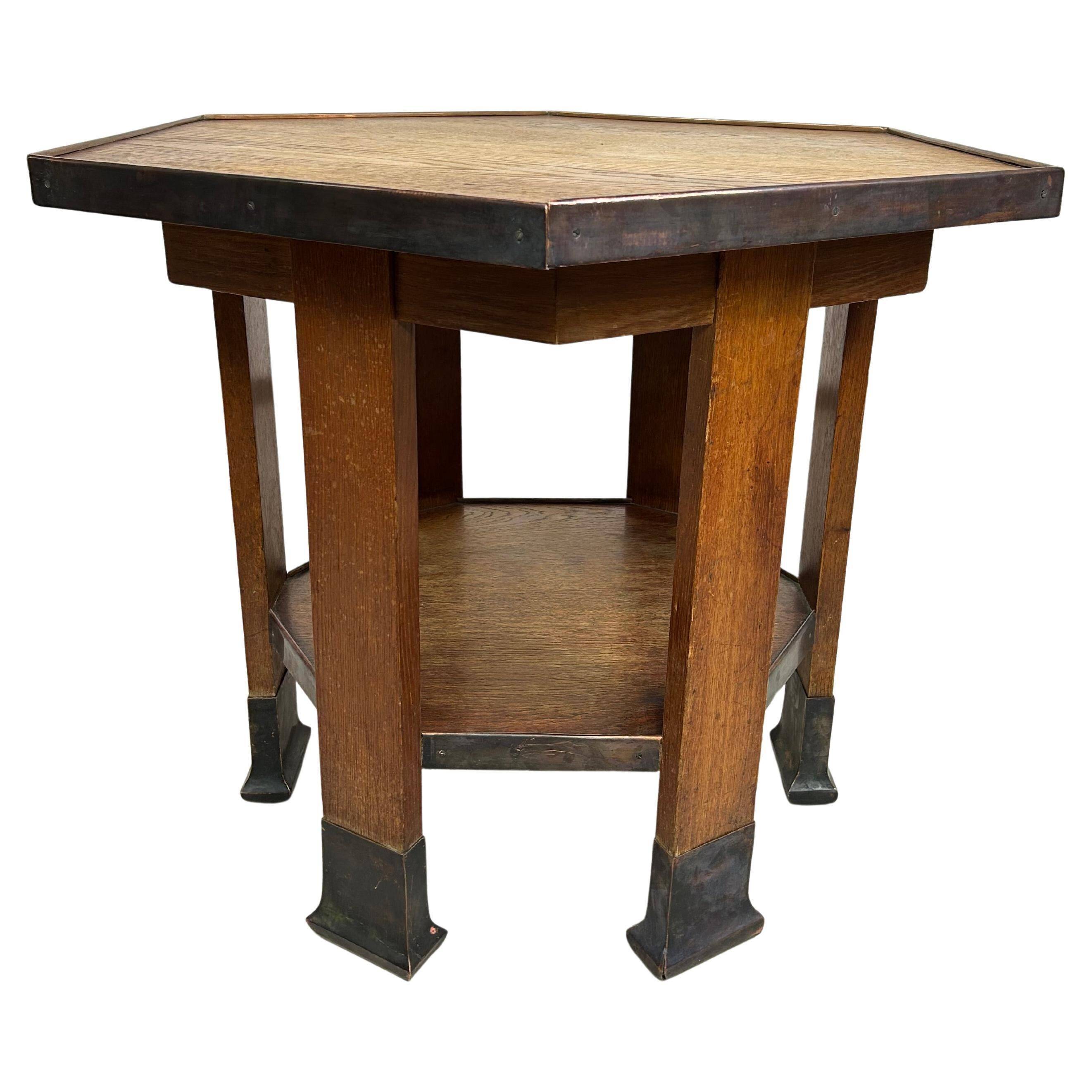 Hexagonal table with six legs in Secession style bordered with brass, attributed to Adolf Loos.
