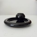 Vintage black ceramic candle holder on a bowl