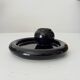 Vintage black ceramic candle holder on a bowl