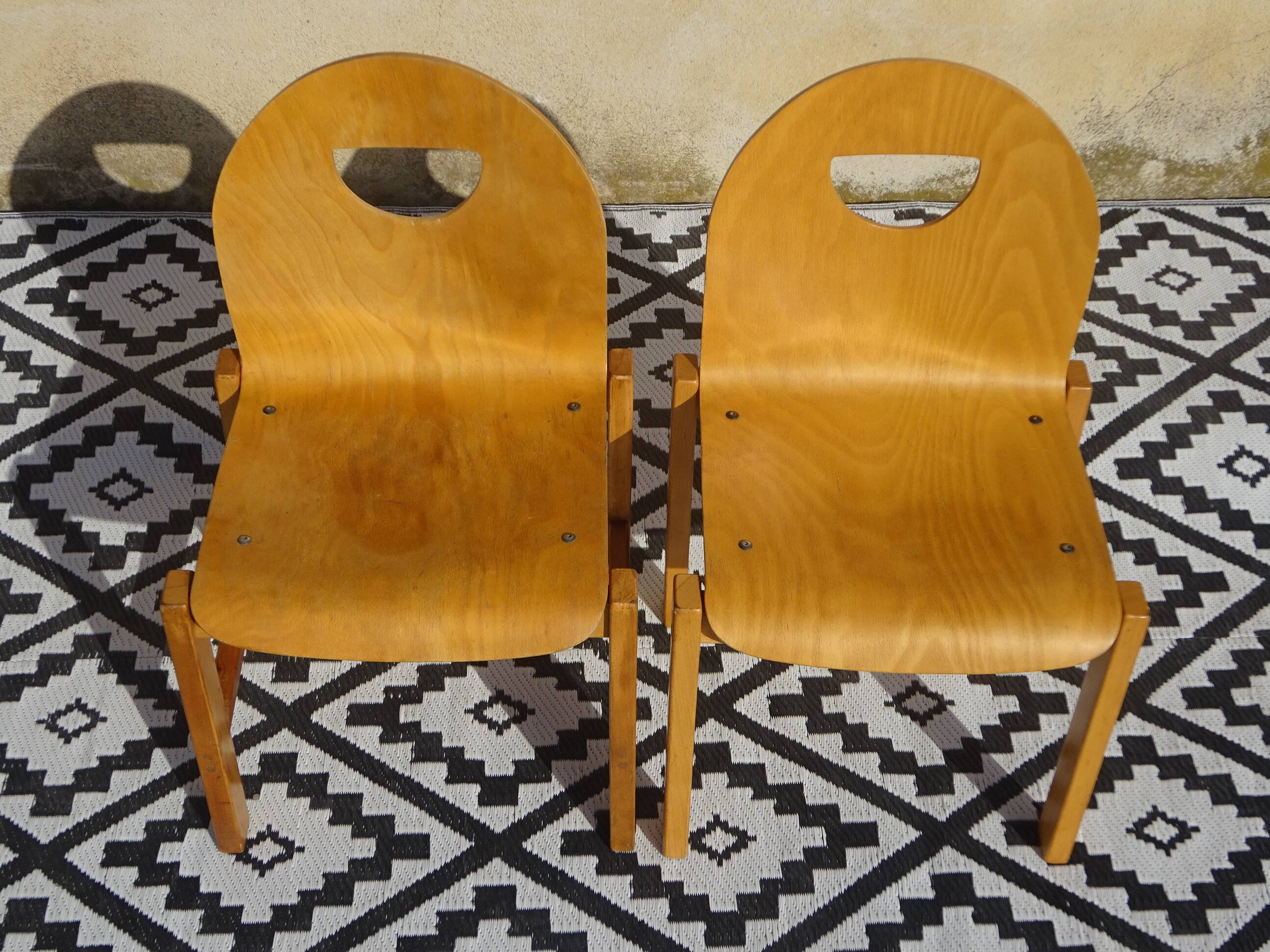 Pair of light wood chairs with post-formed seat and backrest.