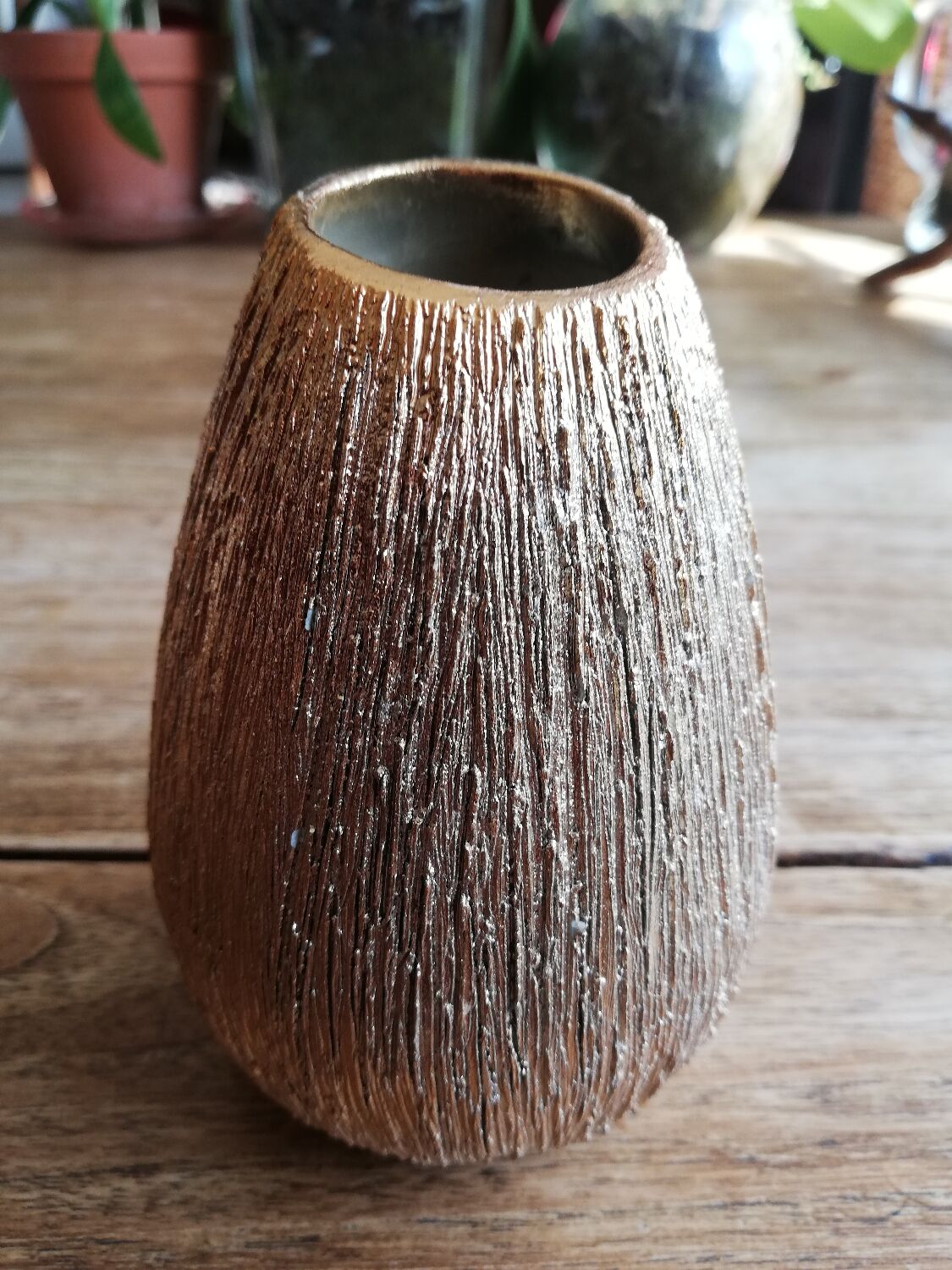 Small asymmetrical golden seed-shaped vase