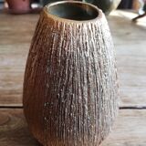 Small asymmetrical golden seed-shaped vase