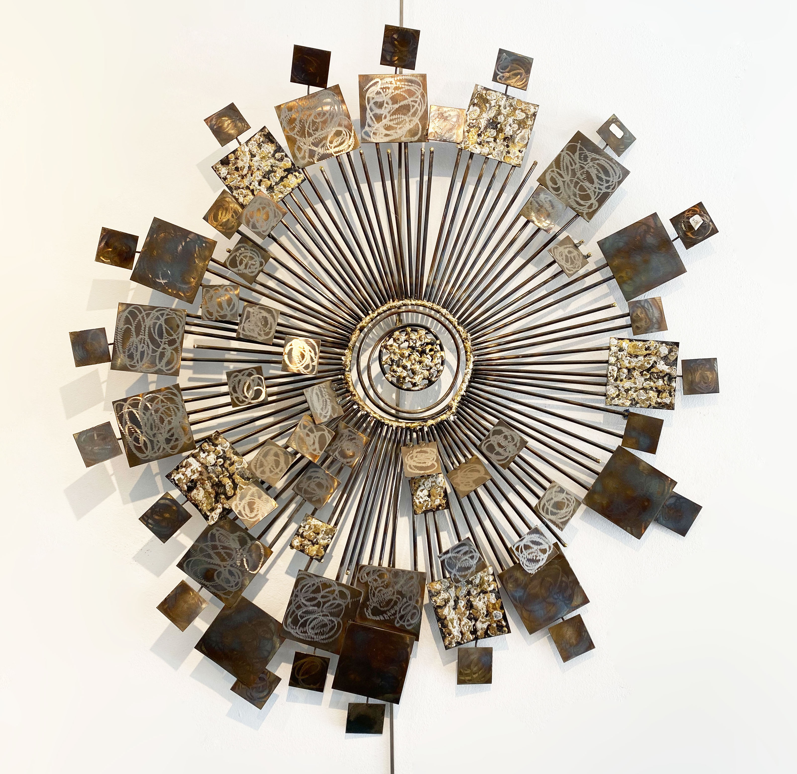 Brutalist Sunburst wall sculpture by Curtis Jere. USA, 2000s