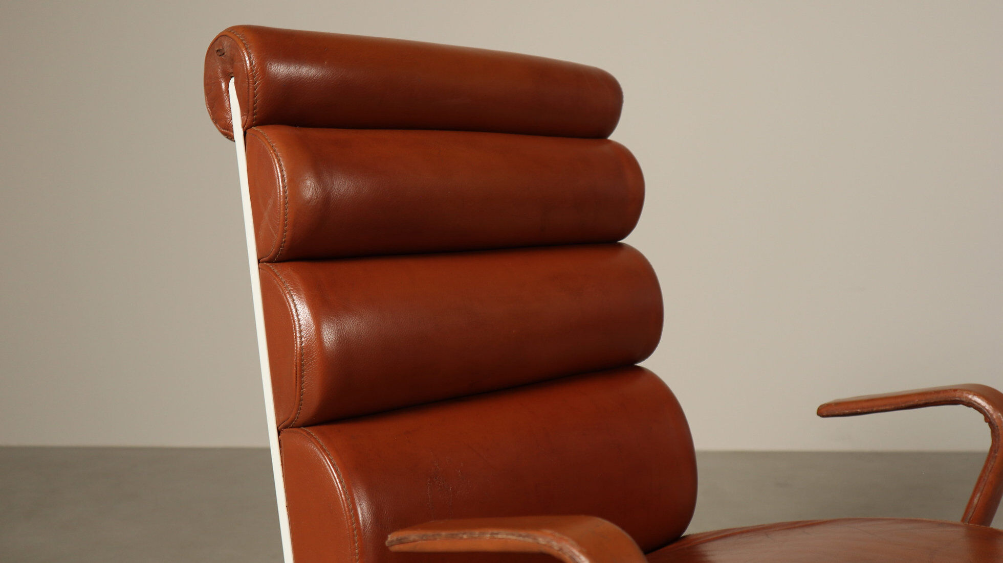 Pair of sculptural cognac leather armchairs, 1970s