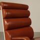 Pair of sculptural cognac leather armchairs, 1970s