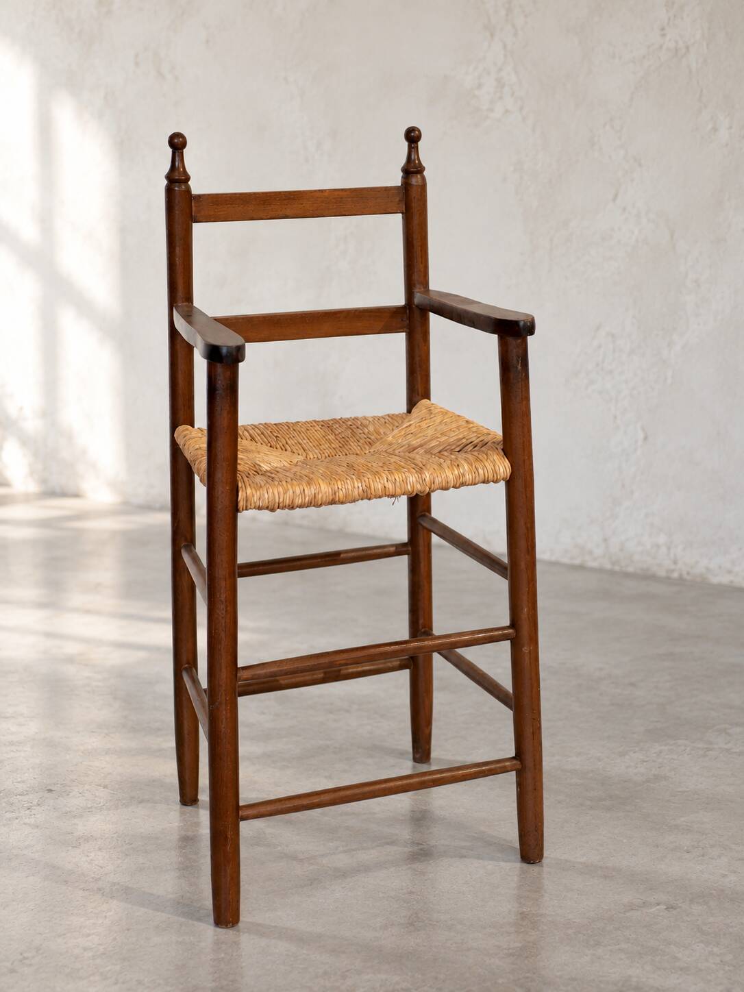 High chair made of straw and wood