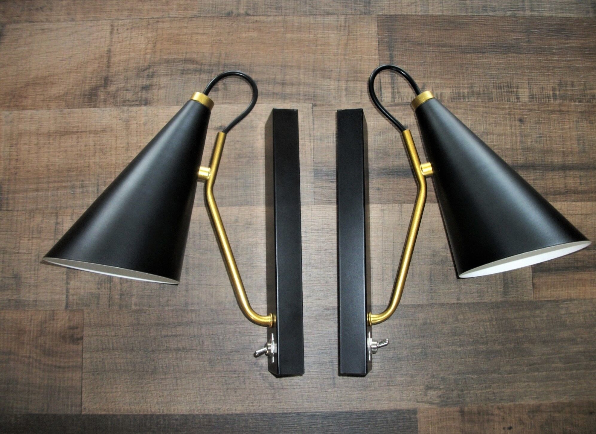 Pair of modernist sconces in black and gold metal