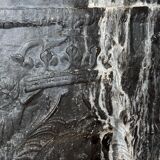 huge old fireplace plate has decoration of angels, crown and fleurs-de-lis