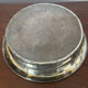 Antique silver-plated bottle coaster with floral decoration.