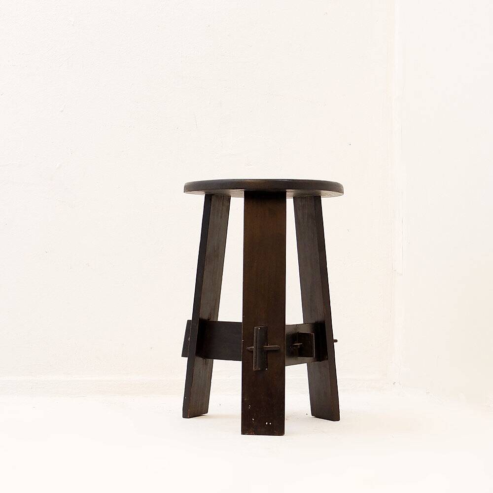 Vintage black-stained wooden tripod stool with mortise joints.