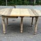Round extendable dining table with flaps, stripped in raw oak, with 4 extensions.