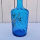 Vintage twisted blue glass carafe with enamel decoration.