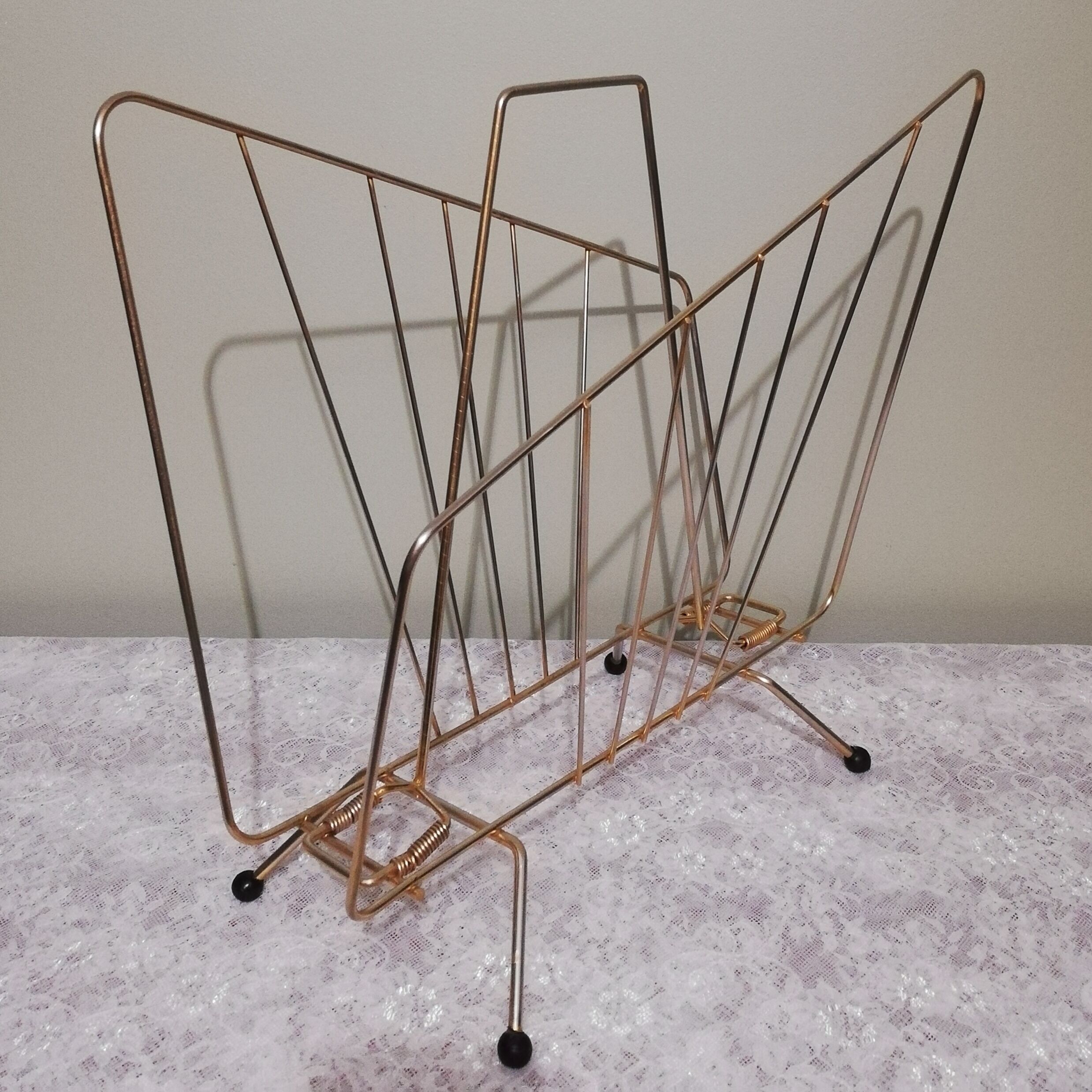 Vintage magazine holder in gilded brass.