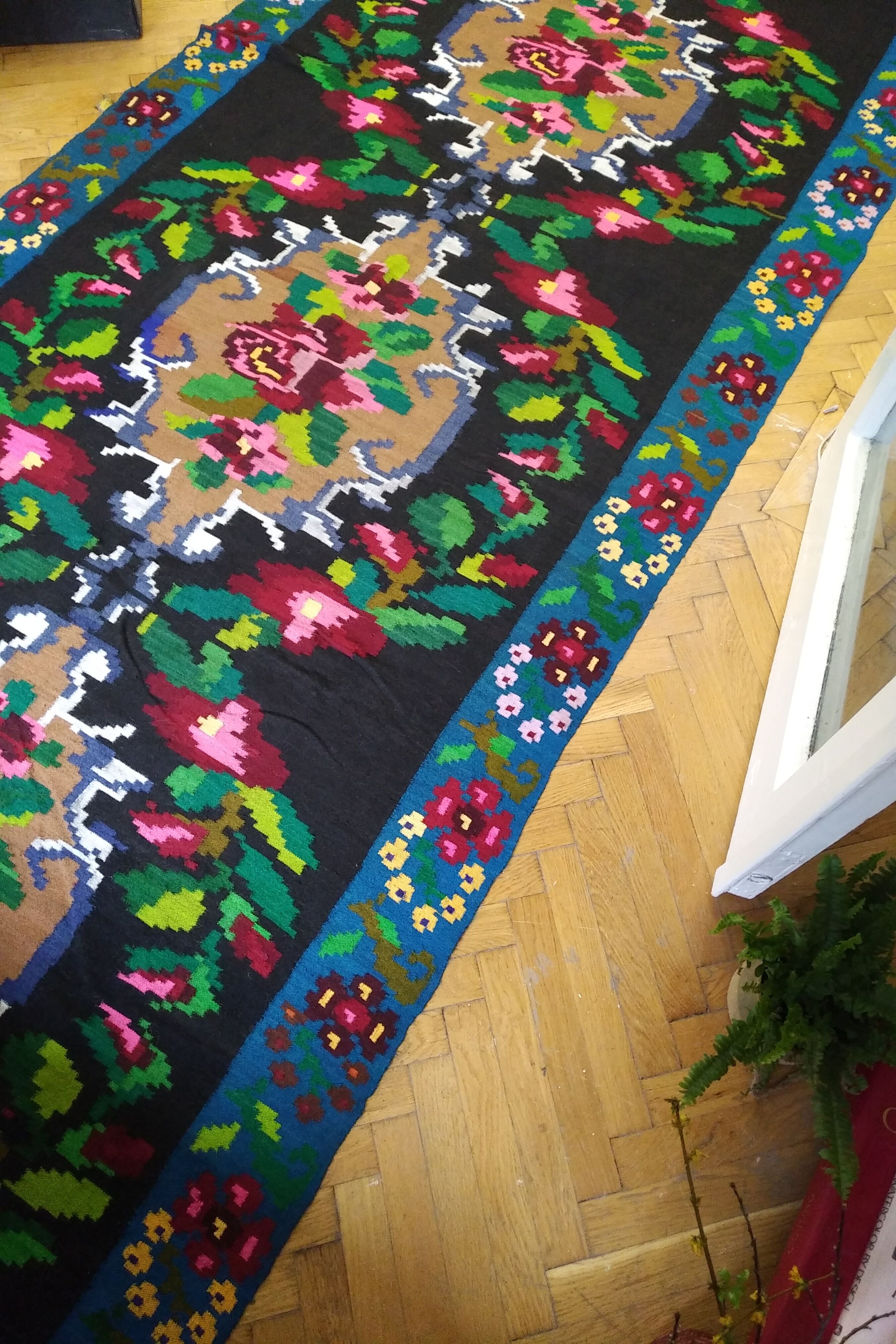 Romanian floral runner rug on blue background
