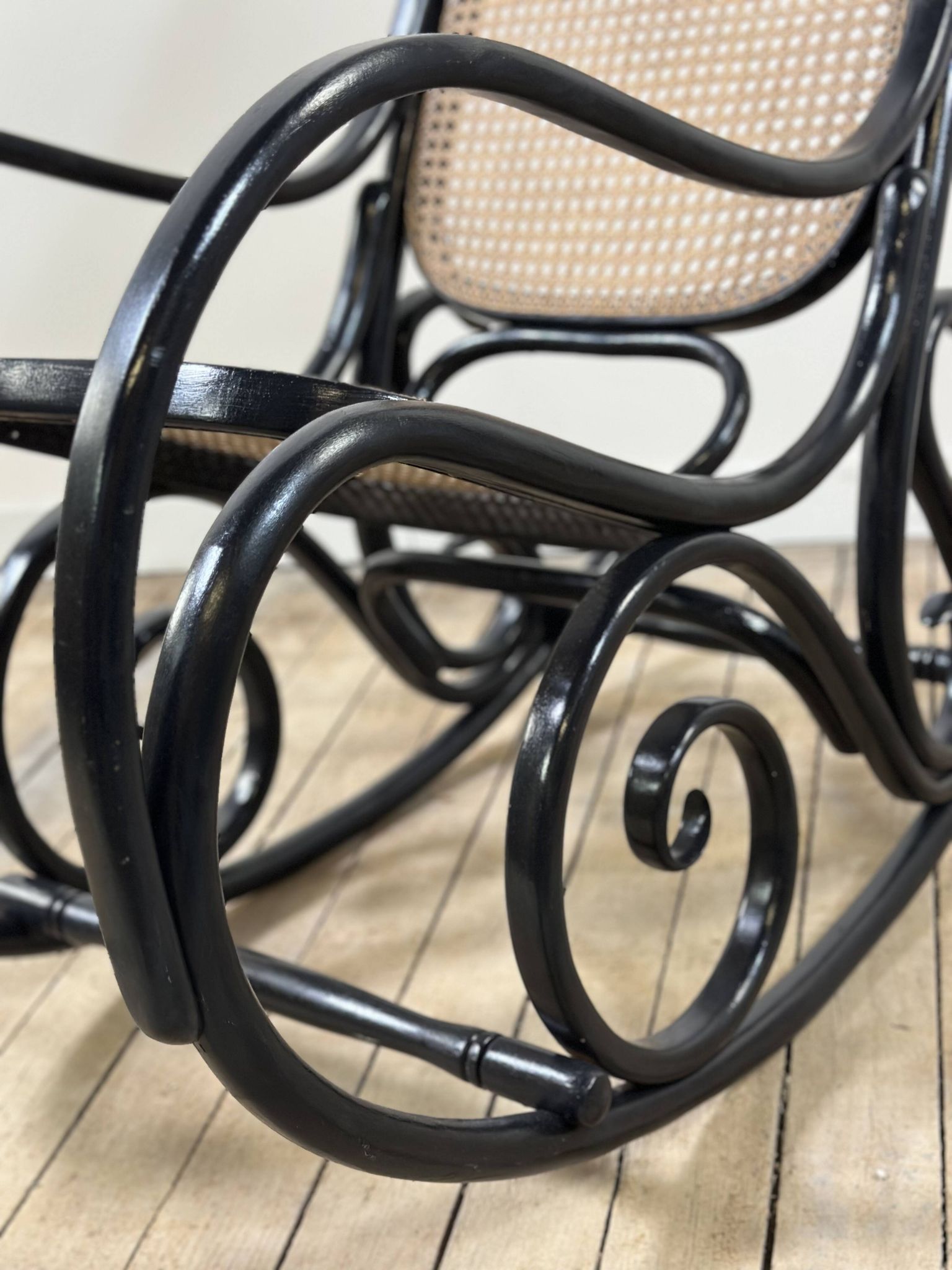 Rocking chair in blackened curved wood and cane, 1900s