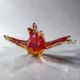 Vintage Murano glass bowl/plate in orange-red with swirling patterns.
