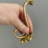 Three old and beautiful brass hooks with decorative motifs