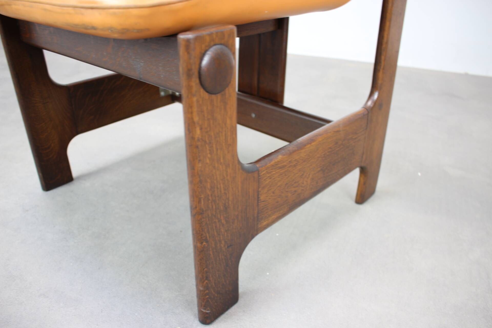 Vintage German sculptural chair from the 1970s in wood with orange faux leather.