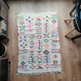 White Moroccan rug with Berber patterns.