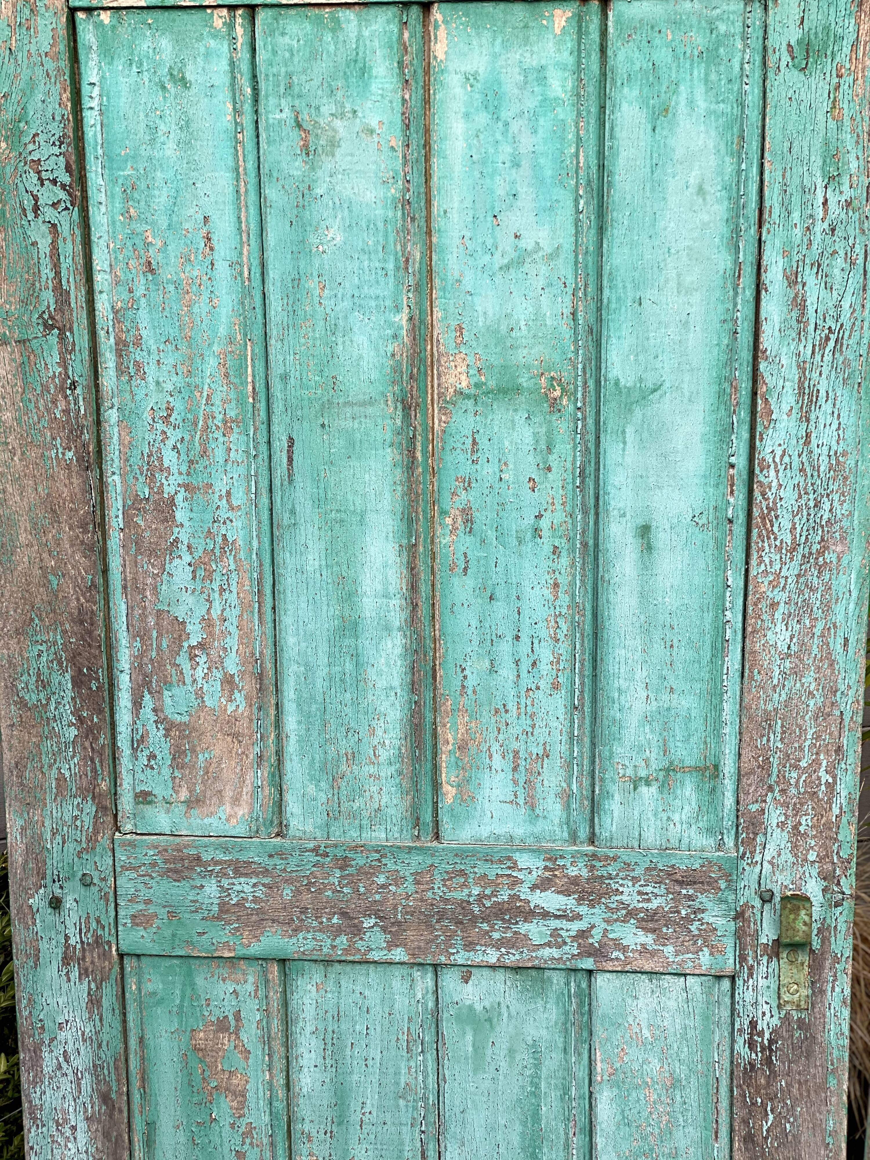 Pair of old wooden shutters green mint color