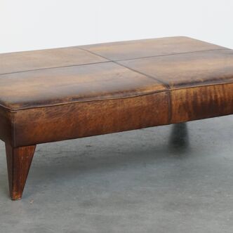 Hocker/coffee table made of sheepskin