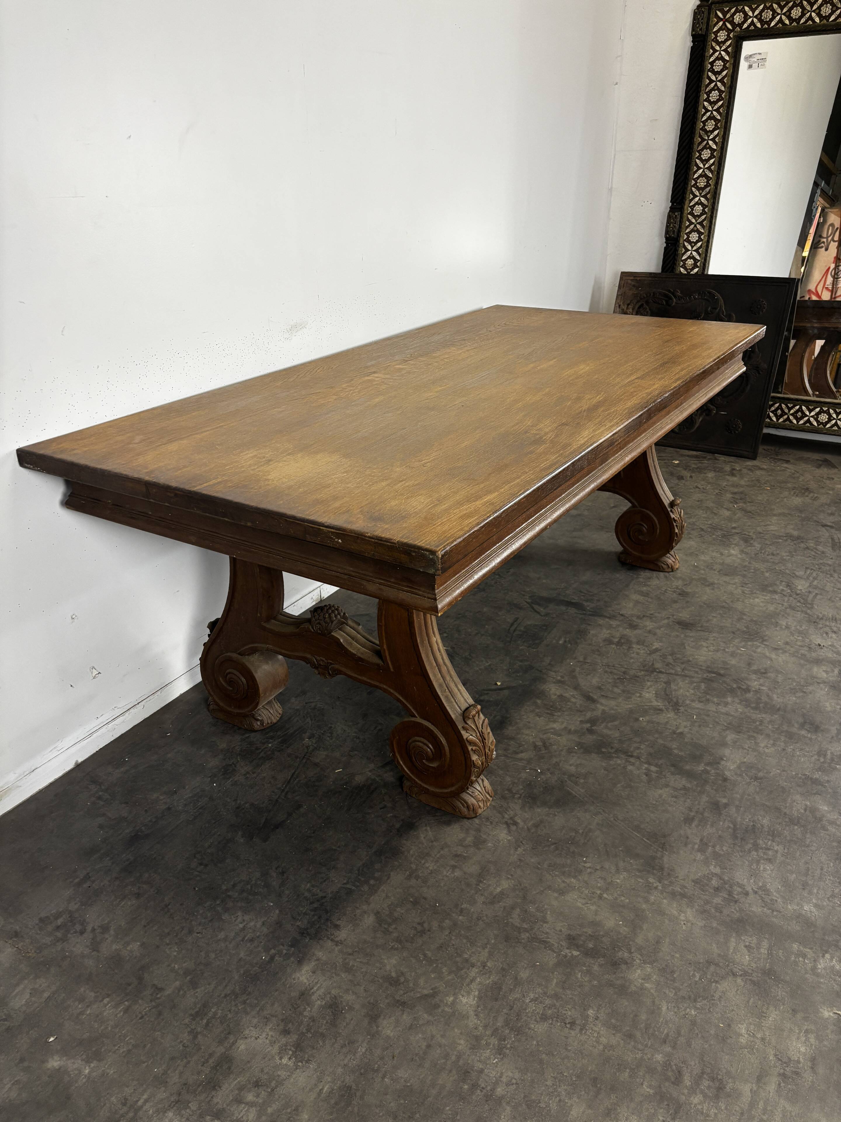 Renaissance-style oak dining table with lyre legs.