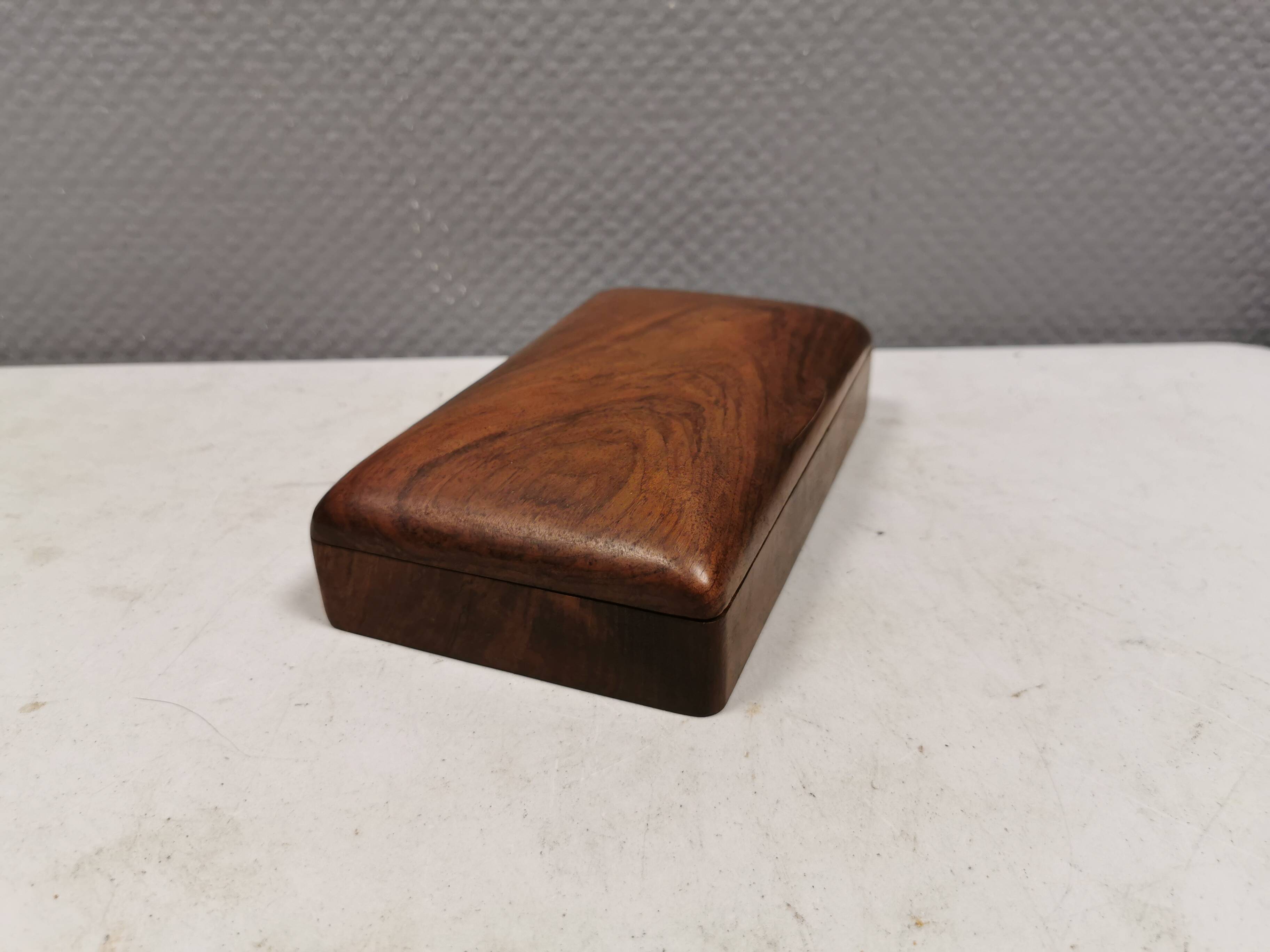 Wooden trinket box for storing jewellery, cigarettes or similar items.