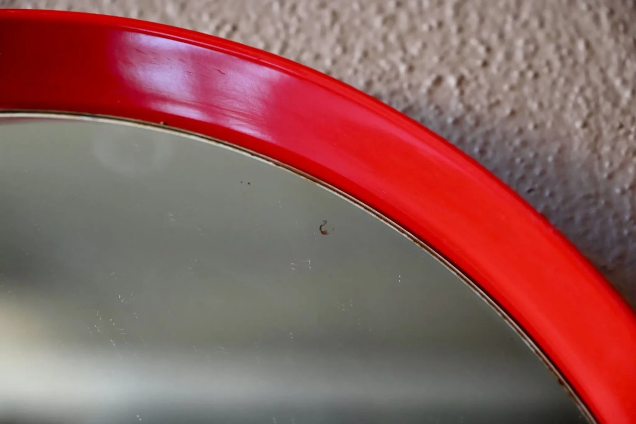 Round Pop Art mirror from the 60s-70s in bright red plastic.