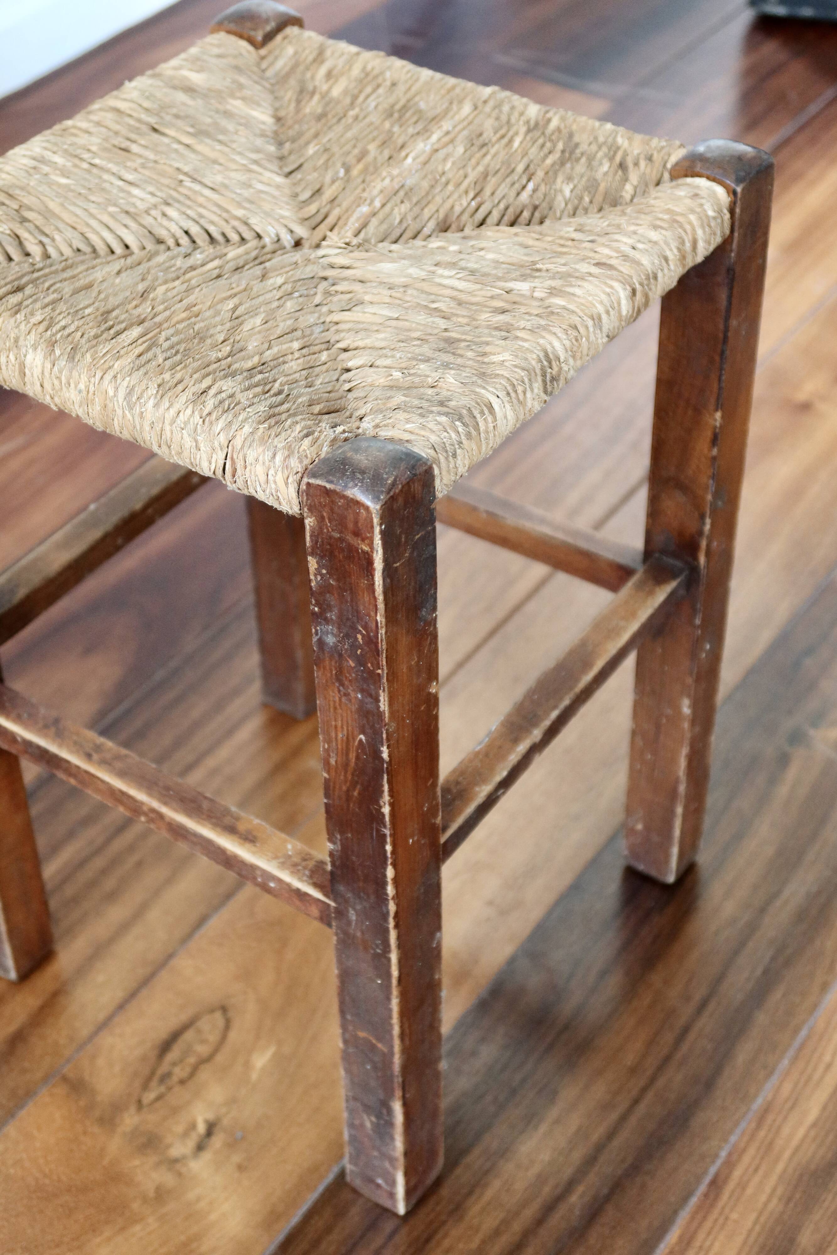 Rustic old stool made of wood and straw.