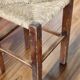 Rustic old stool made of wood and straw.